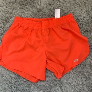 Neon orange Reebok active shorts